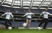 22 July 2003; Armagh players Diarmaid Marsden, left, and Brendan Tierney practices their kicking skills with Martina Farrell, Dublin's Ladies Football captain, at the launch of the MBNA Kick Fada competition thats takes place on the 21st September at the Bray Emmets GAA Club, Co. Wicklow.  Croke Park, Dublin. Picture credit; David Maher / SPORTSFILE *EDI*