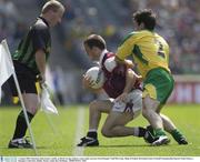 4 August 2003; Linesman John Geaney watches as Derek Savage of Galway comes under pressure from Niall McCready of Donegal during the Bank of Ireland All-Ireland Senior Football Championship Quarter Final match between Galway and Donegal at Croke Park, Dublin. Photo by Ray McManus/Sportsfile