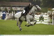 9 August 2003; Roberto Arioldi of Italy competes on Loro Plana Aramis, settles himself after jumping the wall in the Puissance Competition during day three of the Dublin Horse Show at RDS in Dublin. Photo by Ray McManus/Sportsfile