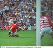 10 August 2003; Wexford's Rory McCarthy shoots the sliothar past Cork corner back Diarmuid O'Sullivan (4) and goalkeeper Donal Og Cusack to score his sides third goal and level the game. Guinness All-Ireland Senior Hurling Championship Semi-Final, Cork v Wexford, Croke Park, Dublin. Picture credit; Ray McManus / SPORTSFILE