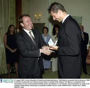 13 August 2003; Former Republic of Ireland and Sunderland player Niall Quinn is presented with an Honorary MBE by British Amabassador for Ireland, Stewart Eldon, on behalf of Her Majesty The Queen, in recognition of his outstanding services to international football and his contributions to UK charities. The presentation was made at the residence of the British Ambassador in Sandyford, Dublin. Picture credit; SPORTSFILE / Haydn West, PA / POOL PHOTO *EDI*