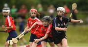 10 June 2018; Katlyn Sheehan of Sarsfields, Co Cork, in action against Ava Killian of Carnmore, Co Galway, during the Division 1 Camogie semi-final between Carnmore, Co Galway, and Sarsfields, Co Cork, at the John West Féile na nGael national competition which took place this weekend across Connacht, Westmeath and Longford. This is the third year that the Féile na nGael and Féile Peile na nÓg have been sponsored by John West, one of the world’s leading suppliers of fish. The competition gives up-and-coming GAA superstars the chance to participate and play in their respective Féile tournament, at a level which suits their age, skills and strengths. Photo by Matt Browne/Sportsfile