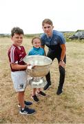 10 July 2018; Michael Fitzsimons of Dublin with Liam Conneely, aged 9, from Barna, Co. Galway, and Leah Conneely, aged 9, from Glen, Co. Wexford, during a visit to Aran Islands GAA club prior to the GAA Hurling and Football All Ireland Senior Championship Series National Launch at the Aran Islands, Co Galway. Photo by Diarmuid Greene/Sportsfile