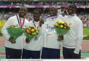 31 August 2003; The Great Britain team who won Silver in the Men's 4 X 100m, from left, Darren Campbell, Christian Malcolm, Marlon Devonish and Dwain Chambers after the presentation ceremony during the ninth day's competition at the 9th IAAF World Championships in Athletics at the Stade de France in Paris, France. Photo by Brendan Moran/Sportsfile