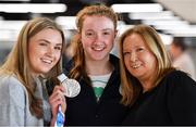 15 October 2018; Niamh Coyne of Team Ireland, from Tallaght, Dublin, with her sister Aoife and mother Paula, and her silver medal from the women's 100m breaststroke, on the Team Ireland swimming team return from the Youth Olympic Games in Buenos Aires at Dublin Airport in Dublin. Photo by Brendan Moran/Sportsfile