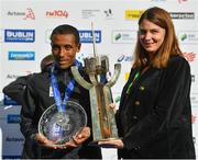 28 October 2018; Asefa Bekele of Ethiopia accepts the Noel Carroll Trophy for top male finisher, presented by Enda Carroll of the Carroll family today at the 2018 SSE Airtricity Dublin Marathon. 20,000 runners took to the Fitzwilliam Square start line to participate in the 39th running of the SSE Airtricity Dublin Marathon, making it the fifth largest marathon in Europe. Photo by Ramsey Cardy/Sportsfile