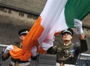 Ag ardú. Members of the Irish Defence Forces Sergeant Brian Harte, right, and Sergeant Ian Jones raise the Tricolour at Croke Park on the morning of the All-Ireland hurling final.    This image may be reproduced free of charge when used in conjunction with a review of the book &quot;A Season of Sundays 2018&quot;. All other usage © SPORTSFILE