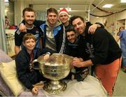 25 December 2018; Jack McCaffrey, Michael Fitzsimons, captain Stephen Cluxton, Bernard Brogan, Michael Darragh Macauley with Séamus Byrne, age 11, from Cabra, Dublin, and the Sam Maguire Cup during the Dublin Football team visit to the Children's University Hospital, Temple Street in Dublin. Photo by Ray McManus/Sportsfile