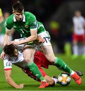 24 March 2019; Paddy McNair of Northern Ireland is tackled by Alyaksandr Martynovich of Belarus during the UEFA EURO2020 Qualifier Group C match between Northern Ireland and Belarus at the National Football Stadium in Windsor Park, Belfast. Photo by Ramsey Cardy/Sportsfile