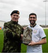 25 March 2019; Kieran McDaid of Colleges & Universities is presented the trophy by Brigadier General Peter O'Halloran the match between Colleges & Universities and Defence Forces at  Athlone Town Stadium in Athlone, Co. Westmeath. Photo by Harry Murphy/Sportsfile