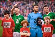 12 April 2019; Republic of Ireland XI players, from left, Robbie Keane, Wayne Henderson and Ian Harte with mascots prior to the Sean Cox Fundraiser match between the Republic of Ireland XI and Liverpool FC Legends at the Aviva Stadium in Dublin. Photo by Stephen McCarthy/Sportsfile