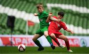 29 May 2019; The SPAR FAI Primary School 5s National Finals took place in AVIVA Stadium on Wednesday, May 29, where former Republic of Ireland International Keith Andrews and current Republic of Ireland women's footballer, Megan Campbell were in attendance supporting as girls and boys from 13 counties battled it out for national honours. The 2019 SPAR FAI Primary School 5s Programme was the biggest yet with a record 37,448 participants from 1,696 schools taking part in county, regional and provincial blitzes nationwide. Matthew Kiernan of Scoil Phádraig Naofa, Rochestown, Co. Cork, in action against Liam Murphy of St. John the Apostle NS, Kncknacarra, Co. Galway, at the Aviva Stadium in Dublin. Photo by Harry Murphy/Sportsfile