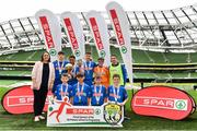 29 May 2019; The SPAR FAI Primary School 5s National Finals took place in AVIVA Stadium on Wednesday, May 29, where former Republic of Ireland International Keith Andrews and current Republic of Ireland women's footballer, Megan Campbell were in attendance supporting as girls and boys from 13 counties battled it out for national honours. The 2019 SPAR FAI Primary School 5s Programme was the biggest yet with a record 37,448 participants from 1,696 schools taking part in county, regional and provincial blitzes nationwide. Pictured are Section C Boys winners, Scoil Mhuire Banrion from Edenderry, Co. Offaly, with Helen Somerville, Spar, right, at the Aviva Stadium in Dublin.   Photo by Sam Barnes/Sportsfile