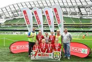 29 May 2019; The SPAR FAI Primary School 5s National Finals took place in AVIVA Stadium on Wednesday, May 29, where former Republic of Ireland International Keith Andrews and current Republic of Ireland women's footballer, Megan Campbell were in attendance supporting as girls and boys from 13 counties battled it out for national honours. The 2019 SPAR FAI Primary School 5s Programme was the biggest yet with a record 37,448 participants from 1,696 schools taking part in county, regional and provincial blitzes nationwide. Pictured are players and coaches from Faha NS, Kerry with Spar Representative Norman Foley. Photo by David Fitzgerald/Sportsfile