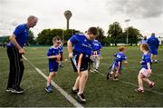 22 June 2019; Ahead of the start of the first ever Bank of Ireland Leinster Rugby Inclusion Camps on the 2nd July in Terenure RFC, the final training session for camp coaches was held in UCD today by Leinster Rugby Spirit Officer, Stephen Gore and Ken Moore, Summer Camp Co-ordinator. Also taking part in the training session were children and parents involved with the Down Syndrome Centre, one of Leinster Rugby’s charity partners. The Bank of Ireland Leinster Rugby Inclusion Camps provide children with all disabilities aged between six and 15, a fun-filled three days of rugby during the summer holidays. The camps will take place in Terenure, Greystones, Navan, Tullamore and Newbridge and are focused on adapting rugby to meet the needs of camp-goers to maximise enjoyment and learning to play the Leinster Way. Further information is available at: https://www.leinsterrugby.ie/camps/inclusion-camps. Pictured are, Charlie O'Neill, aged 11, and Harrison Pender, aged 5, during the training session. Photo by Daire Brennan/Sportsfile