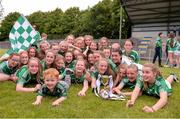 22 June 2019; Limerick players celebrate with the cup with Limerick supporter and son of Limerick manager John Macnamara, Conor, age 3, from Limerick, following the Ladies Football All-Ireland U14 Silver Final 2019 match between Limerick and Tipperary at St Rynaghs in Banagher, Offaly. Photo by Ben McShane/Sportsfile