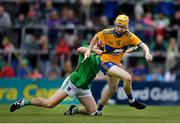 30 June 2019; Shane Meehan of Clare in action against Ronan Lyons of Limerick during the Electric Ireland Munster GAA Hurling Minor Championship Final match between Limerick and Clare at LIT Gaelic Grounds in Limerick. Photo by Brendan Moran/Sportsfile