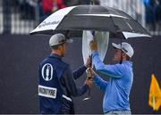 18 July 2019; Robert MacIntyre of Scotland dries his putter under an umbrella on the 18th green during Day One of the 148th Open Championship at Royal Portrush in Portrush, Co Antrim. Photo by Brendan Moran/Sportsfile