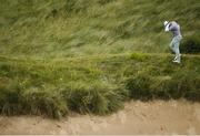 18 July 2019; Gary Woodland of USA removes sand from his hair after playing a shot from a bunker on the 6th hole during Day One of the 148th Open Championship at Royal Portrush in Portrush, Co Antrim. Photo by Ramsey Cardy/Sportsfile