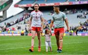 11 August 2019; Colm Cavanagh of Tyrone, left, and his daughter Chloe, leave the pitch with team-mate Michael McKernan after the GAA Football All-Ireland Senior Championship Semi-Final match between Kerry and Tyrone at Croke Park in Dublin. Photo by Brendan Moran/Sportsfile