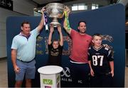 30 August 2019; 10 year old Charlie O'Connor, centre, with dad Ken O'Connor, left, and 11 year old Ken Jr. O'Connor, right, with Ray O'Connor, from Glencar, Co. Kerry, back from New York to watch the All-Ireland Final, with the Sam Maguire Cup at the GAA’s Home for the Match stand in the arrivals hall at Dublin Airport. Photo by Matt Browne/Sportsfile