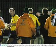 10 December 2003; Finn Harps. manager NoelKing, second from right, points to his watch as referee Eddie Barr, far left, walks off the pitch at the end of the game. eircom league Play-off Final 1st Leg, Finn Harps v Derry City, Finn Park, Ballybofey, Co. Donegal. Picture credit; David Maher / SPORTSFILE *EDI*