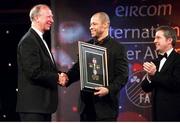 10 February 2002; Jack Charlton, receives his award for personality of the year from Paul McGrath, also pictured is President of the FAI, Milo Corcoran and eircom Chief Executive, Dr. Phil Nolan, (far right) eircom International Awards, Citywest Hotel, Saggart, Dublin. Soccer. Photo by David Maher/Sportsfile