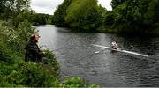 18 May 2020; Mikey Campion of Commercial Rowing Club passes fisherman Ian Murphy as he trains on the River Liffey in Dublin as it resumes having previously suspended all activity following directives from the Irish Government in an effort to contain the spread of the Coronavirus (COVID-19). Rowing clubs in the Republic of Ireland resumed activity on May 18th under the Irish government’s Roadmap for Reopening of Society and Business following strict protocols of social distancing and hand sanitisation among others allowing it to return in a phased manner. Photo by Harry Murphy/Sportsfile