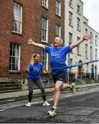 4 July 2020; Freeman of Dublin and former Dublin senior men's team manager Jim Gavin runs to the finish line held by Dublin footballer and secretary of The Dublin Neurological Institute Rebecca McDonnell during the Dublin Neurological Institute 150km Frontline Run at Eccles Street in Dublin. The DNI is a registered charity where we care for patients with neurological diseases including Parkinson, Epilepsy, Motor Neuron Disease, Multiple Sclerosis, Headache, Stroke and many more is holding hold a fundraising run with staff members running this weekend to raise much needed funds. The goal is to run 150km between staff over the course of Saturday the 4th and Sunday the 5th of July. Donations can be made at https://tinyurl.com/yd3a4d8d . The run can be tracked using the free app 'Map My Run' and anyone who wishes to join in the run is very welcome. Photo by David Fitzgerald/Sportsfile
