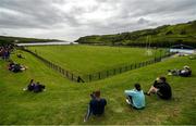 18 July 2020; Spectators watch from the bank overlooking the pitch during the Donegal County Divisional League Division 1 Section B match between Kilcar and Killybegs at Towney Park in Kilcar, Donegal. Competitive GAA matches have been approved to return following the guidelines of Phase 3 of the Irish Government’s Roadmap for Reopening of Society and Business and protocols set down by the GAA governing authorities. With games having been suspended since March, competitive games can take place with updated protocols including a limit of 200 individuals at any one outdoor event, including players, officials and a limited number of spectators, with social distancing, hand sanitisation and face masks being worn by those in attendance among other measures in an effort to contain the spread of the Coronavirus (COVID-19) pandemic. Photo by Seb Daly/Sportsfile
