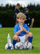 20 July 2020; Rian O'Connor, age 7, from Terenure, sanitises his hands during the Bank of Ireland Leinster Rugby Summer Camp at Westmanstown RFC in Clonsilla, Dublin. Photo by Seb Daly/Sportsfile