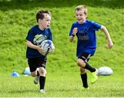 21 July 2020; 7 year old Niall Byrne, in action against his 8 year old brother Conor during the Bank of Ireland Leinster Rugby Summer Camp at Longford RFC in Lisbrack, Longford. Photo by Ramsey Cardy/Sportsfile