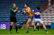 1 November 2020; Gary Brennan of Clare gets away from Robbie Kiely of Tipperary and referee Conor Lane during the Munster GAA Football Senior Championship Quarter-Final match between Tipperary and Clare at Semple Stadium in Thurles, Tipperary. Photo by Diarmuid Greene/Sportsfile