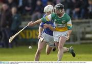 25 January 2004; Fergal Kealey of Offaly in action against Tommy Fitzgerald of Laois during the Walsh Cup match between Offaly and Laois at St Brendan's Park in Birr, Offaly. Photo by Damien Eagers/Sportsfile