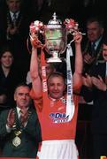 4 May 1997; Shelbourne captain Mick Neville lifts the FAI Cup, watched by FAI President Pat Quigley, left, following his side's victory during the FAI Cup Final match between Derry City and Shelbourne at Dalymount Park in Dublin. Photo by David Maher/Sportsfile