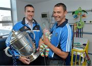 11 July 2013; Dublin hurlers share their victory with children at Temple Street Children's University Hospital. Pictured are Dublin's Peter Kelly with the Bob O'Keeffe Cup and Michael Carton with 11 week old Jack Powell, from Killester, Dublin, during a visit to Temple Street Children's University Hospital, Temple Street, Dublin. Picture credit: Matt Browne / SPORTSFILE