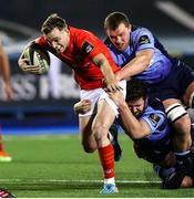 26 February 2021; Nick McCarthy of Munster is tackled by Kirby Myhill and Shane Lewis-Hughes of Cardiff Blues during the Guinness PRO14 match between Cardiff Blues and Munster at Cardiff Arms Park in Cardiff, Wales. Photo by Chris Fairweather/Sportsfile