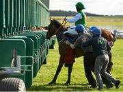 21 March 2021; Church Mountain and jockey James Doyle are helped into the stalls by stall handlers before the start of the Royal Lytham At Irish Emerald Stud C & G Maiden at The Curragh Racecourse in Kildare. Photo by Seb Daly/Sportsfile