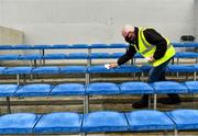 16 May 2021; Clare official Martin Keane sanitises seats in advance of players arriving for the Allianz Hurling League Division 1 Group B Round 2 match between Clare and Wexford at Cusack Park in Ennis, Clare. Photo by Ray McManus/Sportsfile