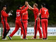 22 May 2021; Joshya Manley of Munster Reds, second right, celebrates with team-mate Murray Commins after bowling out Jack Tector of Leinster Lighting during the Cricket Ireland InterProvincial Cup 2021 match between Munster Reds and Leinster Lightning at Pembroke Cricket Club in Dublin. Photo by Harry Murphy/Sportsfile