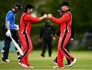22 May 2021; Seamus Lynch of Munster Reds, right, celebrates with team-mate Tyrone Kane after catching out Lorkan Tucker of Leinster Lighting during the Cricket Ireland InterProvincial Cup 2021 match between Munster Reds and Leinster Lightning at Pembroke Cricket Club in Dublin. Photo by Harry Murphy/Sportsfile