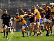 16 May 2021; Ian Galvin of Clare fails to hold the sliotar ahead of Kevin Foley of Wexford and players from both sides during the Allianz Hurling League Division 1 Group B Round 2 match between Clare and Wexford at Cusack Park in Ennis, Clare. Photo by Ray McManus/Sportsfile
