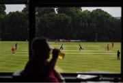 30 June 2021; Gerry McGuire, from Belfast, enjoys a pint inside the Pavillion bar as Luke Georgeson and Harry Tector of Northern Knights make a run during the Cricket Ireland InterProvincial Cup 2021 match between Northern Knights and Munster Reds at Bready Cricket Club in Stormont in Belfast. Photo by David Fitzgerald/Sportsfile