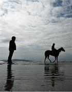 7 July 2021; Stellify with Owen Moss, centre, and Trading Point with Ciara Robinson watched by trainer Ado McGuinness on the gallops at South Beach in Rush, Co. Dublin as they gear up for the iconic Galway Races Summer Festival that takes place from Monday 26th July to Sunday 1st August. Photo by David Fitzgerald/Sportsfile