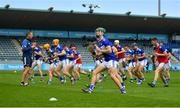 10 July 2021; Sean Downey of Laois warms-up alongside team-mates before the GAA Hurling All-Ireland Senior Championship preliminary round match between Antrim and Laois at Parnell Park in Dublin. Photo by Seb Daly/Sportsfile