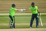 22 July 2021; Paul Stirling of Ireland, left, fist bumps team-mate Andrew Balbirnie during the Men's T20 International match between Ireland and South Africa at Stormont in Belfast. Photo by David Fitzgerald/Sportsfile