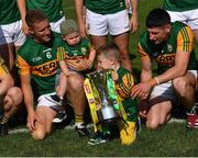 25 July 2021; Kerry footballer Gavin Crowley, 6, with his son Arlo and Paul Geaney with his son Paidi, as they celebrate with the cup after the Munster GAA Football Senior Championship Final match between Kerry and Cork at Fitzgerald Stadium in Killarney, Kerry. Photo by Piaras Ó Mídheach/Sportsfile