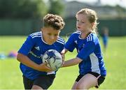 13 August 2021; Jason Aspen, age 10, and Mia van der Krogt, age 9, in action during the Bank of Ireland Leinster Rugby Summer Camp at Tallaght RFC in Dublin. Photo by Seb Daly/Sportsfile