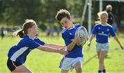 13 August 2021; Cruz Corcoran, age 10, and Mia van der Krogt, age 9, in action during the Bank of Ireland Leinster Rugby Summer Camp at Tallaght RFC in Dublin. Photo by Seb Daly/Sportsfile