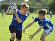 13 August 2021; Lihann De Wet, age 10, left, and Cruz Corcoran, age 10, in action during the Bank of Ireland Leinster Rugby Summer Camp at Tallaght RFC in Dublin. Photo by Seb Daly/Sportsfile
